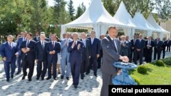 Azerbaijani President Ilham Aliyev (front), who took over from his father, attending a ceremony to mark new water supplies to the city of Kurdamir.