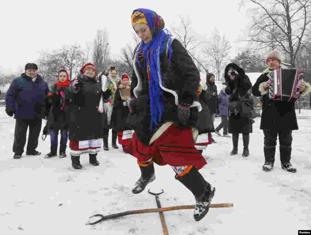 A woman dressed in traditional costume dances during celebrations of Orthodox Christmas at a compound of the National Architecture Museum in Kyiv on January 7. (Reuters/Valentyn Ohirenko)