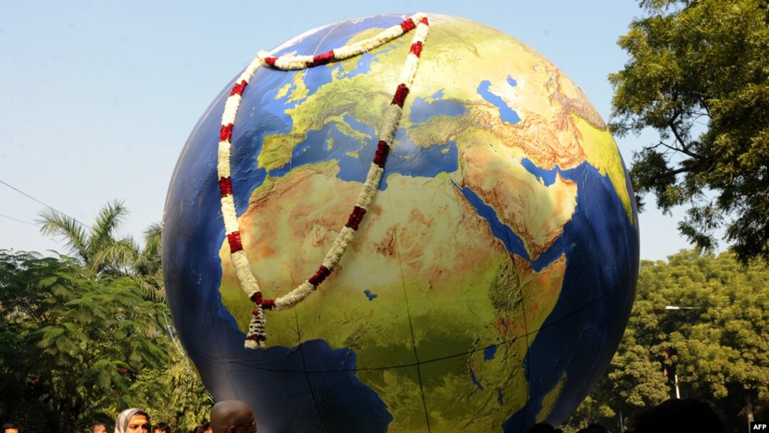 Greenpeace activists carry a globe during a mock funeral procession in New Delhi in December.