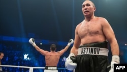 Germany's Manuel Charr (left) celebrates after winning the WBA world heavyweight boxing title in a bout against Russia's Aleksandr Ustinov (right) on November 25. 