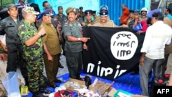 security personnel inspects seized items after they raid what believed to be an Islamist safe house in the eastern town of Kalmunai, Sri Lanka