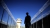 FILE: A US soldier is silhouetted as he looks on during a media tour of Bagram prison in 2009.