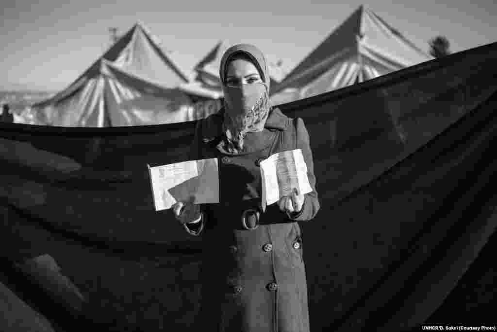 Tamara, 20, poses for a portrait in the Adiyaman refugee camp in Turkey. Her family fled Idlib after their home was partially destroyed. &quot;We spent 40 days on the Syrian side of the border with very little water and no electricity. The hygiene there was very poor. I got food poisoning and was sick for a week,&quot; she says. Tamara brought her diploma, which will help her continue her education in Turkey. 