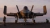 A US F-35C fighter jet is chained down on the flight deck of the USS Abraham Lincoln aircraft carrier at an undisclosed location in the Middle East. 