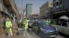 Workers in Iran disinfect streets in central Tehran against the novel coronavirus.