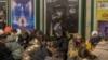 People take shelter in a Kyiv subway station during an air alert in the Ukrainian capital on November 25.