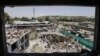 Workers remove debris from a damaged area on June 1 a day after a suicide bomb attack near the foreign embassies in Kabul.