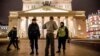 A police officer and a security staff member speak with a passerby outside the Bolshoi Theatre in Moscow after a bomb threat in early November.