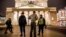 A police officer and a security staff member speak with a passerby outside the Bolshoi Theatre in Moscow after a bomb threat in early November.