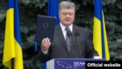 Ukrainian President Petro Poroshenko displays the fully ratified Association Agreement between Ukraine and the European Union in Kyiv on July 13.