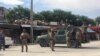 Afghan security forces keep watch outside a mosque where a blast occurred in Kabul on May 24.