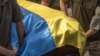 Ukrainian soldiers carry a coffin, covered with the national flag, of a Ukrainian serviceman Yurii Yurchenko, who was killed fighting Russian troops in the Lugansk region, during the funeral service at the Saint Michael's Golden-Domed Monastery in Kyiv, o