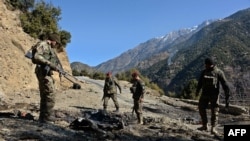 Afghan security personnel patrol during an ongoing anti-Taliban operation in Dangam district near the Pakistan-Afghanistan border in eastern Kunar Province in January.