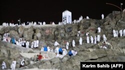 Muslim pilgrims walk and pray on Mount Arafat on August 30. 