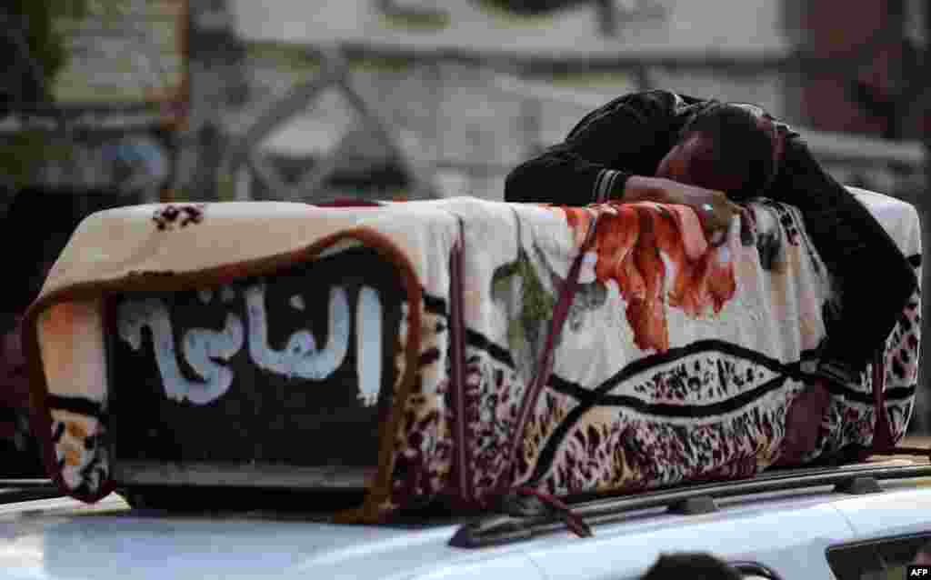 An Iraqi man mourns over the coffin of a relative who was killed in a bomb attack in the Baghdad Shi'ite suburb of Sadr City. (AFP/Ahmad al-Rubaye)