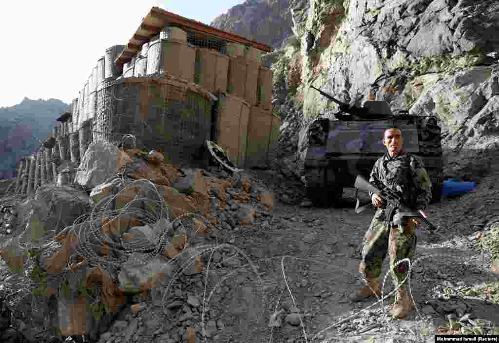 An Afghan National Army soldier stands guard at an isolated checkpoint on the highway between Jalalabad and Kabul on July 8.&nbsp;