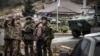 NAGORNO-KARABAKH -- Russian peacekeepers (R and 3rdR) stop a car at their checkpoint outside the city of Stepanakert, November 13, 2020