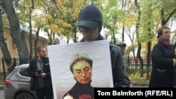 A man holding a portrait of Russian journalist Anna Politkovskaya in Moscow on October 7, 2016, to commemorate the 10th anniversary of her murder.