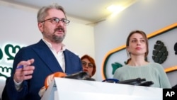 Nika Gvaramia, leader of the Coalition for Change (left), speaks to the media beside Nana Malashkhia, who leads the Coalition for Change parliament list, at the coalition's headquarters in Tbilisi on October 27.