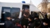Полиция задерживает сторонников оппозиции в Алматы во время парламентских выборов в Казахстане 10 января.