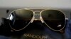 U.S. -- A pair of Randolph Engineering Concorde teardrop sunglasses, in 23-karat gold finish with polarized American gray lenses, rest on a table at the company where they are made, in Randolph, Massachussets, June 17, 2021