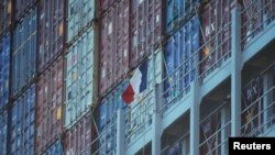 FILE PHOTO: A French flag flies next to containers on the mega cargo ship "Antoine de Saint Exupery" of the French shipping company CMA CGM, in the Total Terminal International Algeciras (TTIA) in the port of Algeciras, Spain May 31, 2018. REUTERS/Jon Naz