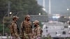 Pakistani soldiers stand guard on a street leading to the Red Zone area after tightened security measures on April 24.