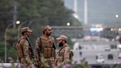 Pakistani soldiers stand guard on a street leading to the Red Zone area after tightened security measures on April 24.