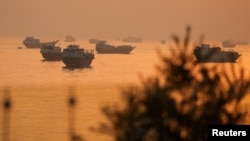 Vessels float in the Strait of Hormuz, as seen from Musandam, Oman.