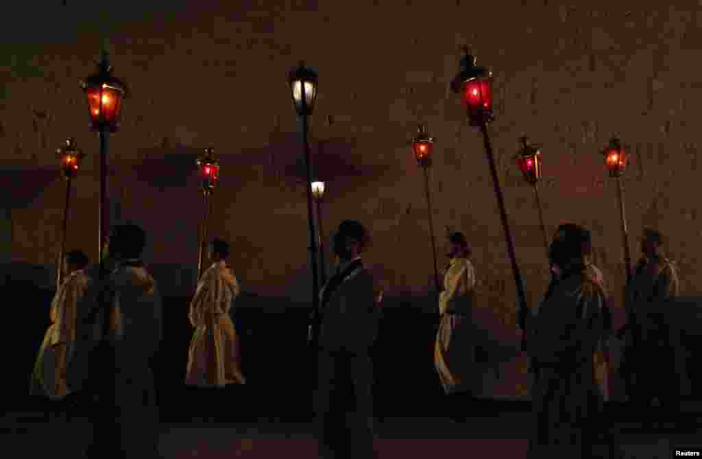 People carry lanterns during the "Za Krizem" procession as they pass through the Vrboska village on Hvar Island. "Za Krizen" is a night procession that takes place on the Thursday before Easter on Hvar. The procession, which has been held for five centuries, is a unique ceremony marked by solemn piety and serves as an important expression of religious and cultural identity of Hvar islanders.(Reuters/Antonio Bronic)