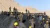 Miners wait on September 16 to remove the bodies of their colleagues who died in a mine collapse in the Ruyi Du Ab district of Samangan Province.