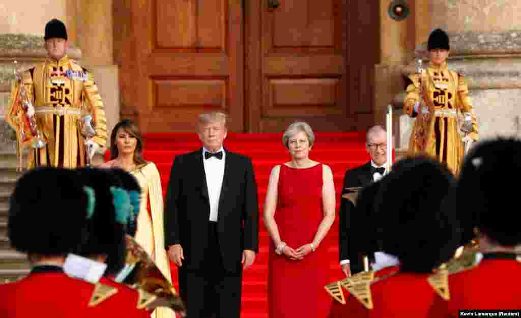 U.K. -- British Prime Minister Theresa May and her husband Philip stand together with U.S. President Donald Trump and first Lady Melania Trump at the entrance to Blenheim Palace, where they are attending a dinner with specially invited guests and business