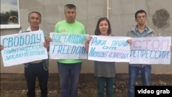 Amangeldy Orazbaev (left) and Marua Eskendirova (second right) attend a protest rally in Oral in June.