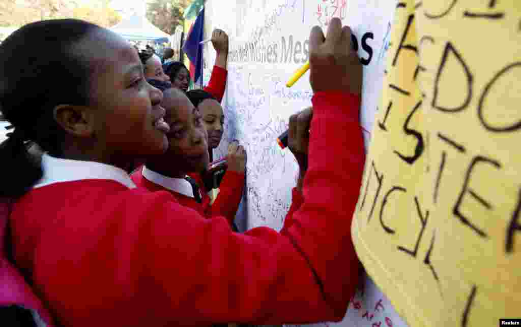 Well-wishers write messages of support outside the hospital in Pretoria where Mandela is being treated.