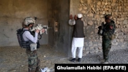 Afghan soldiers conduct a security check during operations in Achin district of the eastern Nangarhar province in January