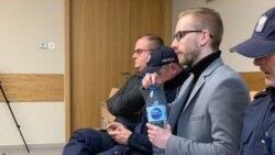 Michal Prokopowiczsitting (wearing glasses) in a courtroom in Krakow, Poland, on January 14, 2019.