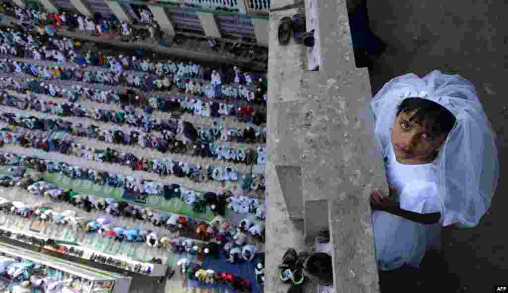 A young Nepalese child looks on as early morning Eid al-Fitr prayers are performed at Kashmiri Mosque in Kathmandu.