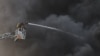 Рятувальники гасять пожежу, що виникла після російського удару, Київ, 10 червня 2025 року