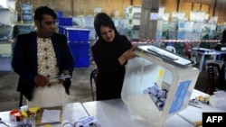 Afghan election workers count ballots.