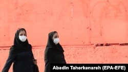 IRAN -- Iranian women wearing face masks walk in a street in Tehran, September 29, 2020