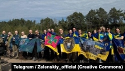 Ukrainian prisoners released in a swap with Russia pose for a photo on September 13.