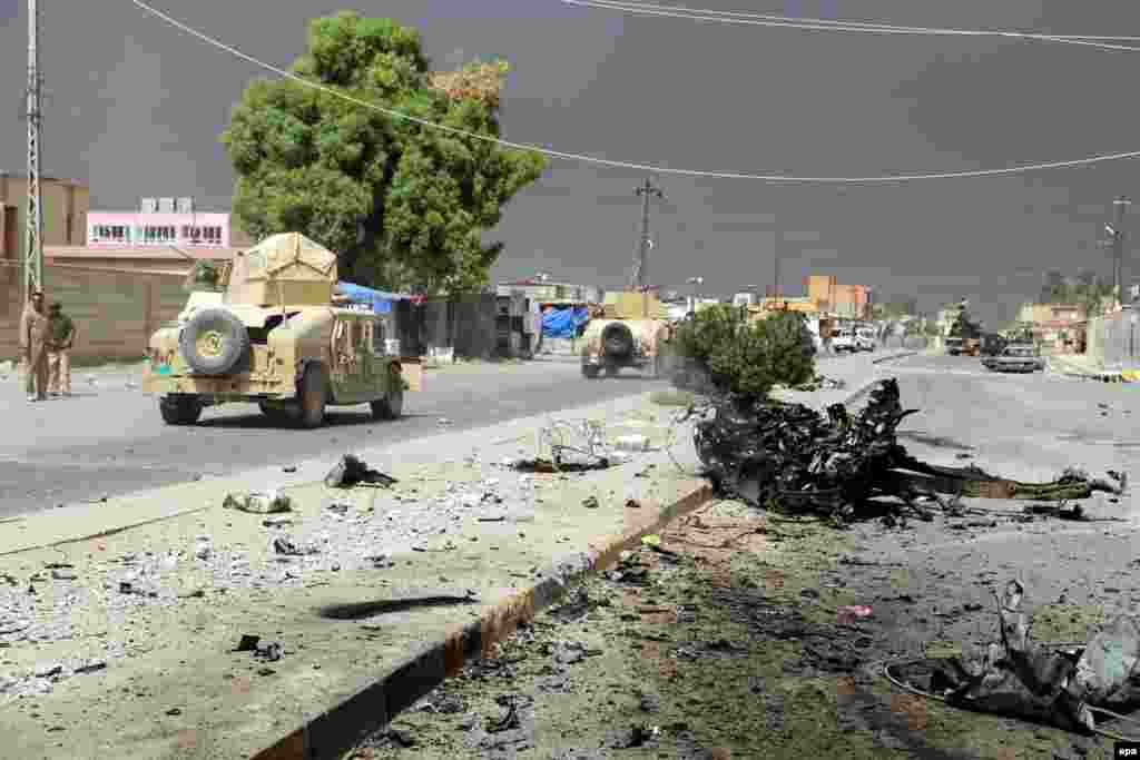 An Iraqi military convoy advances inside the recently recaptured city of Shirqat in northern Iraq. Iraqi security forces gained full control over the city after days of clashes with militants from the Islamic State. (epa/Baraa Kanaan)