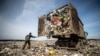 A truck dumps garbage at the Yadrovo site outside Moscow.