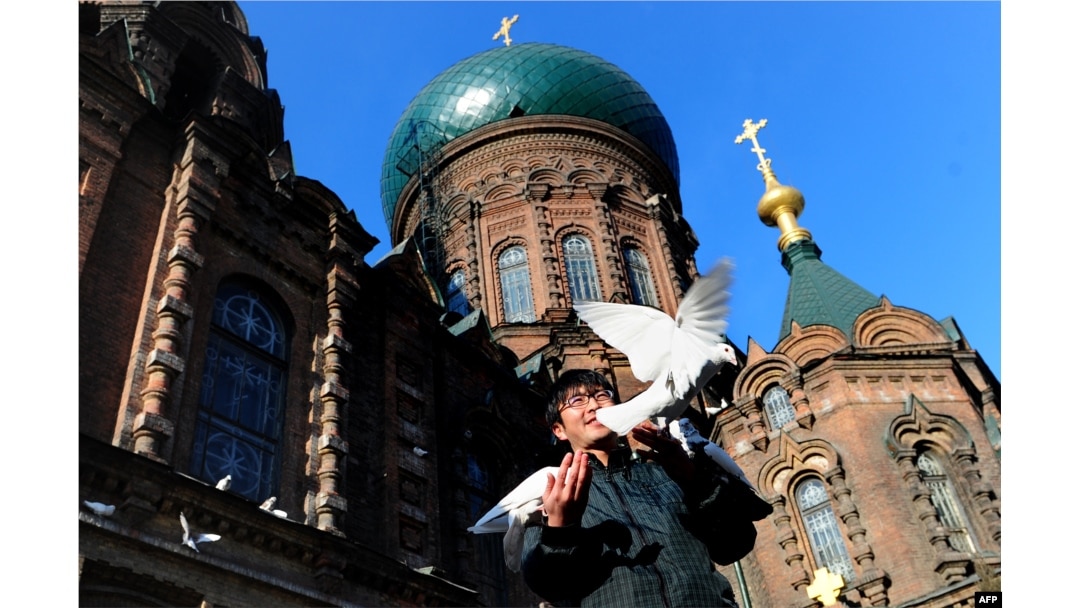 A man stands outside Harbin's St. Sophia Cathedral, a large Orthodox church that reflects the Chinese city's unique history with Russia.
