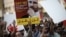 Bahraini protesters hold a placard portraying Sheikh Ali Salman, head of the Shiite opposition movement Al-Wefaq, during a demonstration against his arrest on June 16, 2015, in the village of Jidd Hafs, west of Manama.