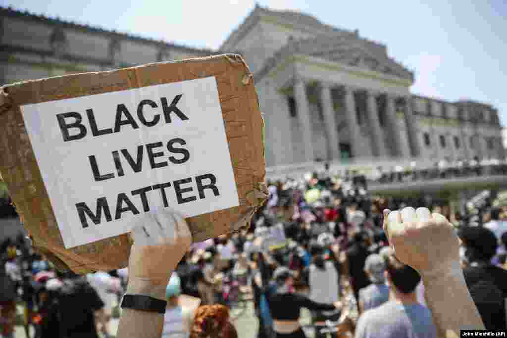 A protester holds a sign that reads "BLACK LIVES MATTER" during a Juneteenth rally outside the Brooklyn Museum, Friday, June 19, 2020, in the Brooklyn borough of New York. 