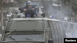 Egyptian riot police used tear gas in battles with protesters January 28 in Cairo.