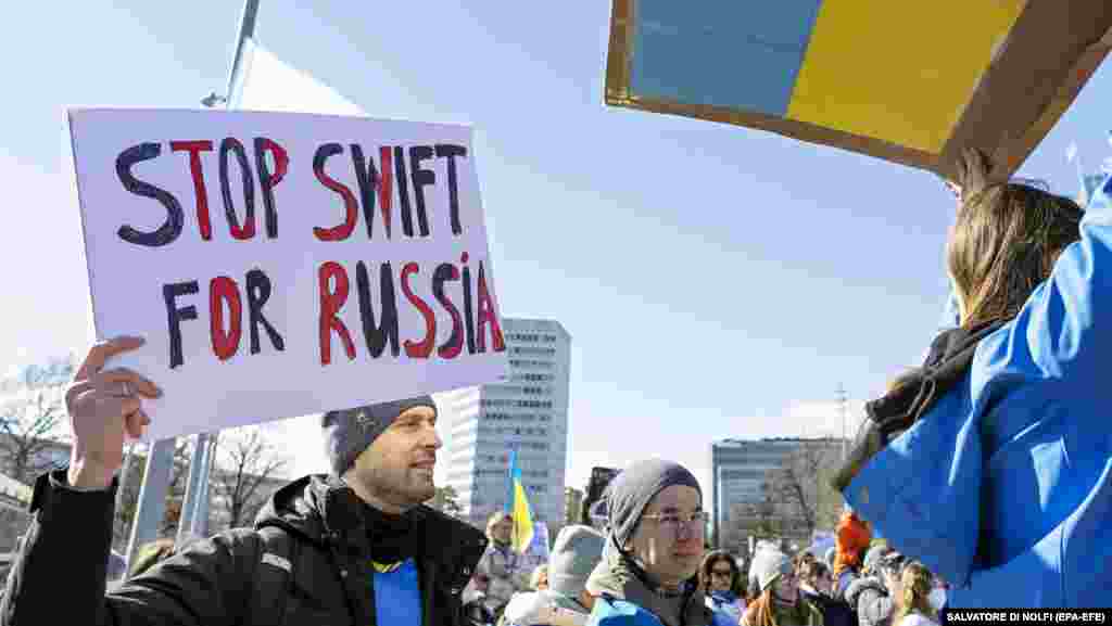 A demonstrator holds a sign while protesting during a rally in Geneva on February 26.