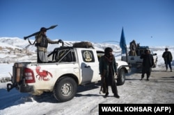 A Hazara militia patrol a road in Wardak Province.