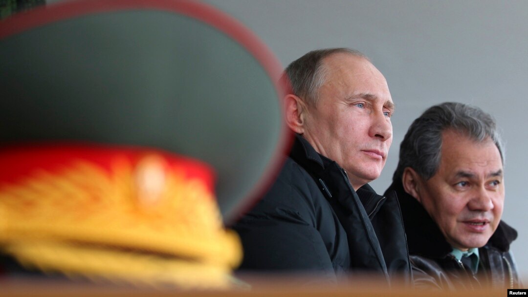 Russian President Vladimir Putin (left) with Defense Minister Sergei Shoigu at the Raevsky training ground in Krasnodar region on March 29